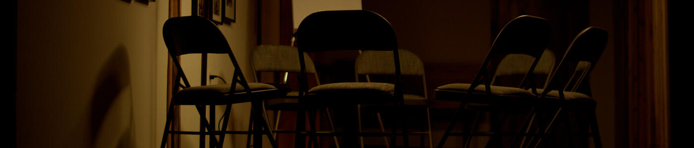 Image: Still from the film of a circle of empty chairs