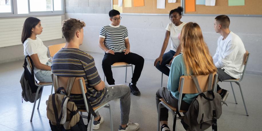 Photo: Six students sitting in a dialogue circle