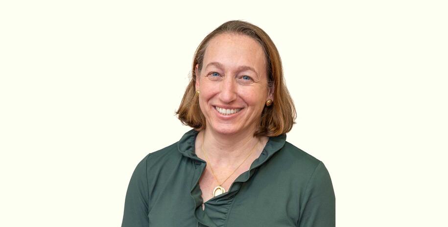 Photo of Catherine Bueker wearing a green shirt on a white background