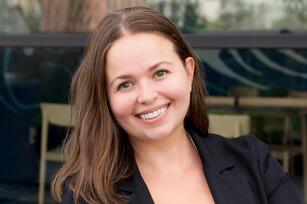 Photo of a woman with brown shoulder length hair and a black jacket
