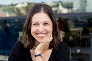 Photo of a woman with brown shoulder length hair and a black shirt